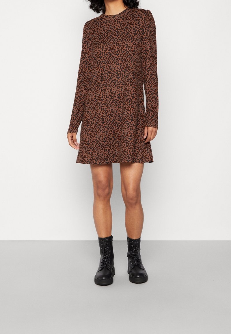 Robe longue à manches longues à imprimé léopard marron avec une coupe décontractée, fabriquée dans un tissu doux ; associée à des bottes noires à lacets. Encolure ronde simple.