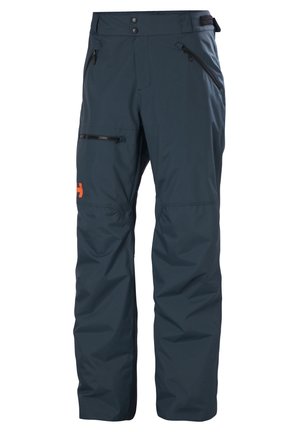 Waterdichte skibroek in donkerblauw, met een zachte textuur, ritszakken, een verstelbare tailleband en een oranje logo-accent.