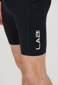 Black athletic shorts made from moisture-wicking material. Features mesh panels for breathability and white "LAB ELITE" logo printed on the side.