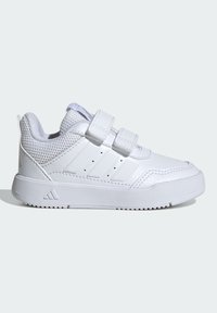 Valged tossud võrgusilmadega, haak- ja silmastrapsudega, tekstuuriga kummitaldadega ning kolmete horisontaalse triibuga küljel.