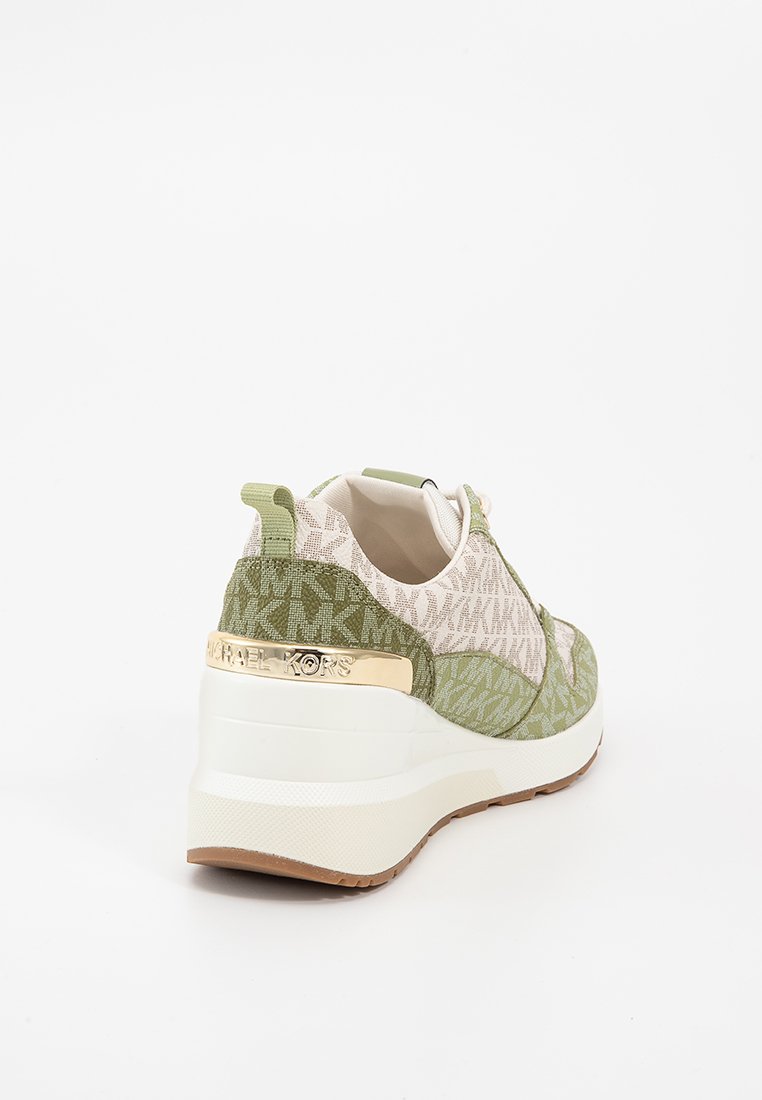 Sneaker verde e beige con tessuto a motivo, suola a zeppa bianca e dettaglio dorato sul tallone. Presenta un design testurizzato e materiali a contrasto.