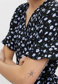 Abito nero con maniche corte, caratterizzato da un motivo floreale di fiori blu e bianchi. Tessuto leggero con design a portafoglio.