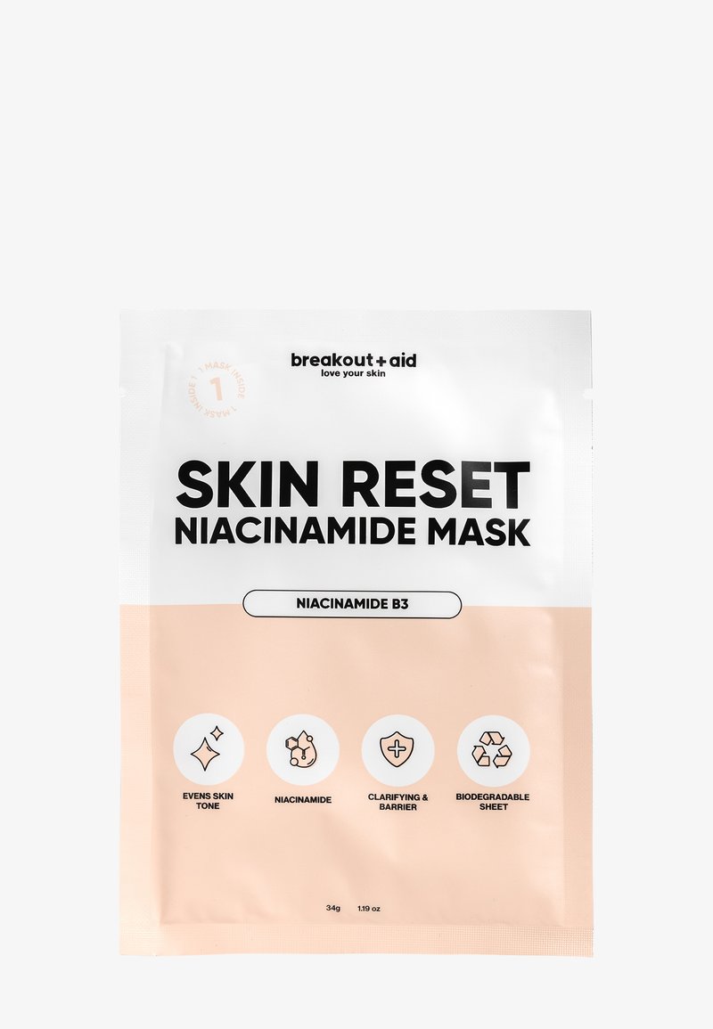 Emballage du masque Skin Reset Niacinamide avec un dessus blanc et un bas pêche. Présente un texte noir en gras, des icônes indiquant les bienfaits, et une note sur la feuille biodégradable.