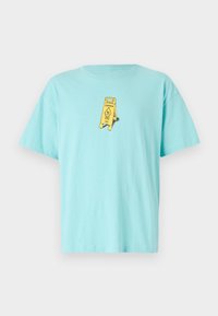 Light blue cotton t-shirt featuring a yellow "Caution" sign graphic on the front. Relaxed fit with short sleeves and a round neckline.