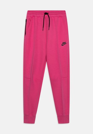Jasnoróżowe spodnie dresowe Nike z czarnym sznurkiem, elastycznym pasem, boczną kieszenią na zamek i logo na lewej udzie, ułożone płasko na białym tle.