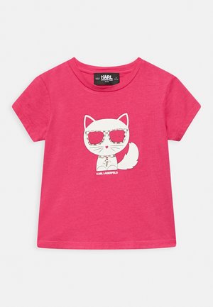 Jasnoróżowa dziecięca koszulka z krótkim rękawem z białym kotem z kreskówki w dużych okularach przeciwsłonecznych i obroży, oznaczona napisem "KARL LAGERFELD".