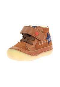 Chaussures pour tout-petits en suede et cuir marron avec une semelle en caoutchouc jaune, à lacets à l'avant et bande Velcro, avec des étoiles bleues et des détails de couture blanche.