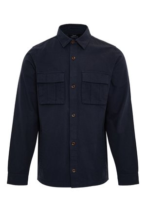 Navy knoopshirt gemaakt van katoen met een kraag, twee borstzakken en bruine knopen. Heeft lange mouwen en een rechte zoom.