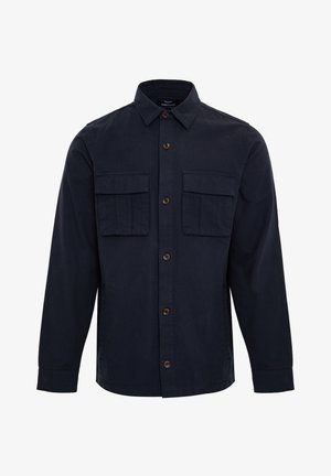 Marineblaue Button-Up-Hemd aus Baumwolle mit Kragen, zwei Brusttaschen und braunen Knöpfen. Hat lange Ärmel und einen geraden Saum.