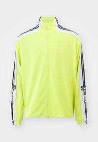 Bright neon yellow jacket with a high collar, zip closure, white accents, and black stripes on sleeves, made from lightweight fabric.