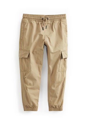 Pantalon cargo beige avec taille élastique, cordon de serrage, poches à rabat latérales et poignets élastiqués aux chevilles.