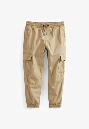 Beige cargobukser med elastisk talje, snøre, sidelommer med klap og elastiske manchetter ved anklerne.