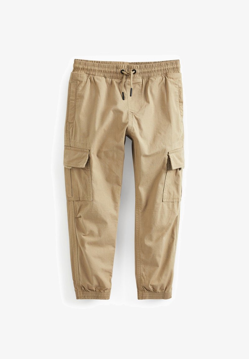 Pantalon cargo beige avec taille élastique, cordon de serrage, poches à rabat latérales et poignets élastiqués aux chevilles.