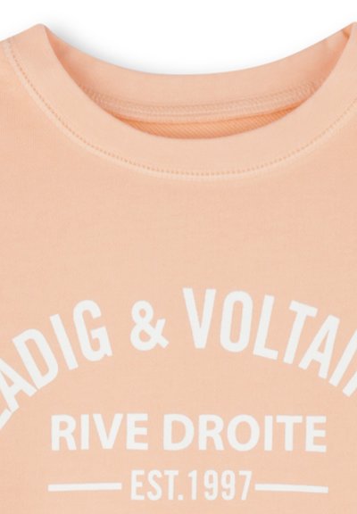 Perzikkleurig katoenen t-shirt met een ronde hals en witte bedrukkingen met de tekst “RIVE DROITE EST.1997” met gebogen accenten.