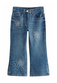 Jeans i jeansblått med utsvängda ben och framfickor. Har glittrande rhinestones i ett mönster på benen. Obehandlad sidsöm.