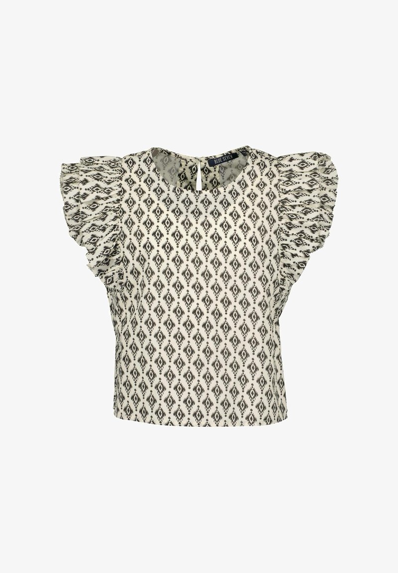 Blouse blanche à manches courtes avec motif losange noir et manches à volants, col rond et fermeture par bouton à œillet dans le dos.