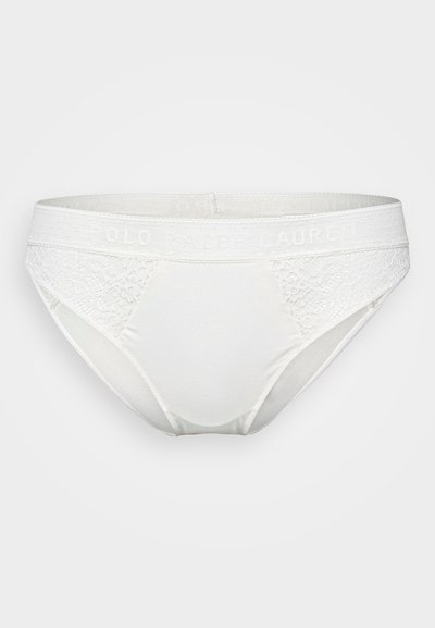 Fehér női fehérnemű csipke díszítéssel és puha elasztikus derékrésszel, amelyen a "POLO RALPH LAUREN" logó található. Simaság és formázott fazon jellemzi.