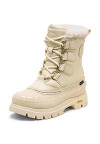 Beige vedenkestävä lumisaapas, jossa on tekoturkiksen vuori, nauhavarustus, kumipohja, moniväriset pinnat ja metallikoristeet. Vibram-logoa on läsnä.