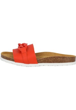 Red slide sandal with a glossy material and decorative knot detail. Cork footbed with white rubber outsole, showcasing a flat profile.