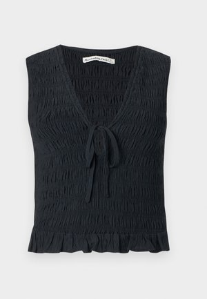 Haut noir sans manches avec encolure en V, texture froncée, détail de nouage à l'avant et ourlet à volants. Fabriqué à partir d'un tissu léger et élastique.
