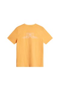 Gul bomulls t-shirt med korta ärmar. Har en geometrisk vit design på baksidan. Rundhalsad stil, slät textur och avslappnad passform.