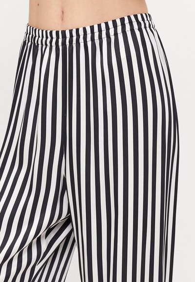 Black and white striped trousers with an elastic waistband, lightweight, smooth texture, featuring vertical stripes evenly spaced.