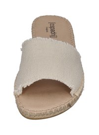 White canvas slide sandal with a frayed strap and a natural jute rope sole. Features a smooth inner lining and stitched accents.