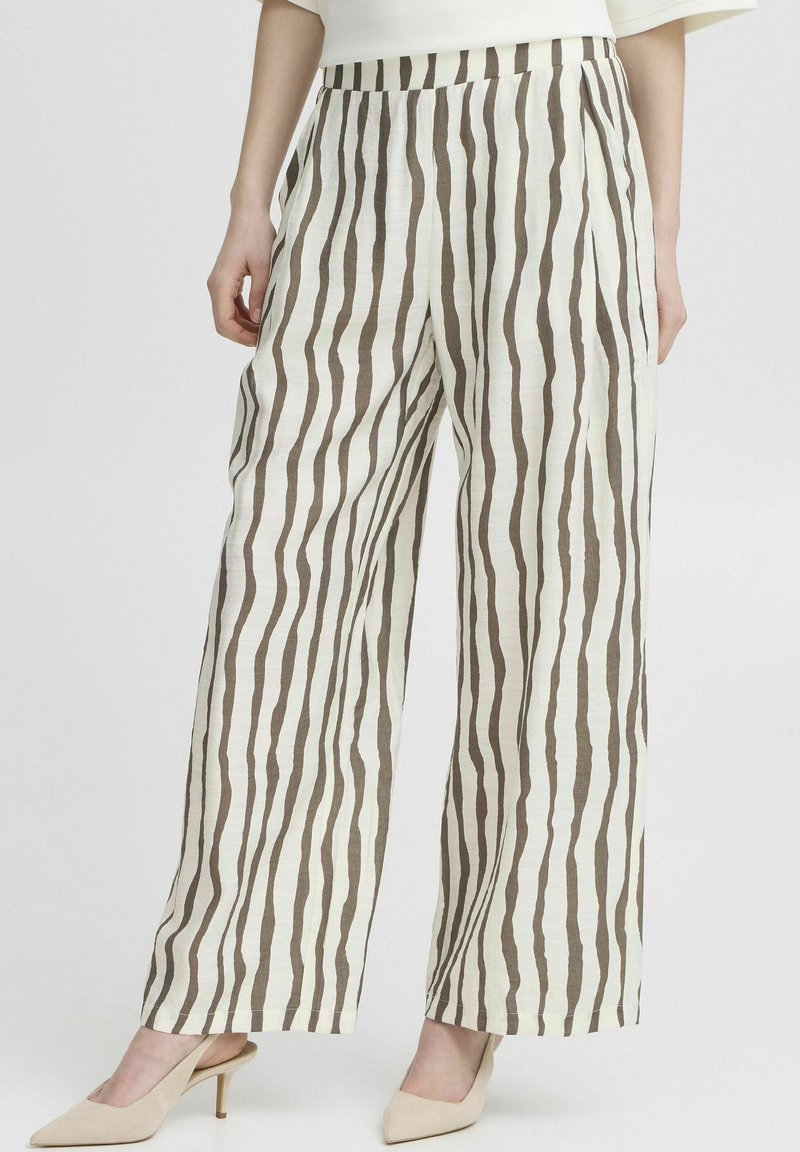 Wide-leg trousers made of lightweight fabric, featuring vertical brown stripes on a cream background. Worn with beige heels.