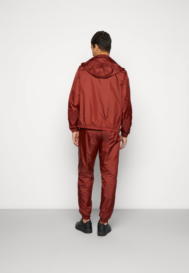 brown and white nike tracksuit