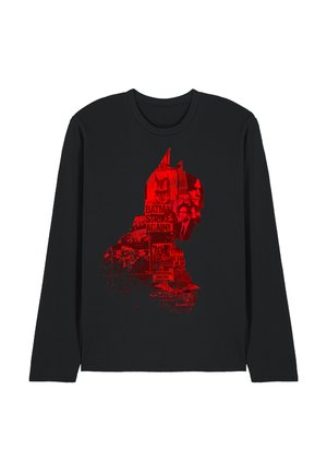 Black long-sleeve shirt with a red Batman silhouette filled with newspaper clippings and images related to Batman.