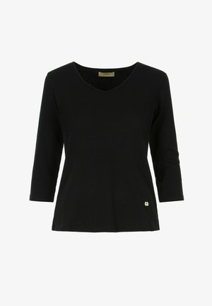 Czarny top z długim rękawem, z dekoltem w kształcie V, o prążkowanej fakturze i z małym metalicznym logo przy dolnej krawędzi. Wykonany z miękkiego, elastycznego materiału.