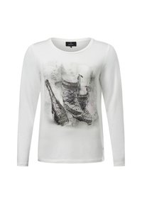 White long-sleeve shirt featuring a printed design of sparkling shoes and a champagne bottle, with a soft texture and crew neckline.