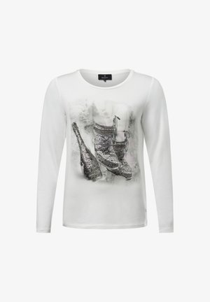 White long-sleeve shirt featuring a printed design of sparkling shoes and a champagne bottle, with a soft texture and crew neckline.