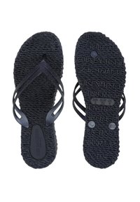 Chanclas negras con suela de goma texturizada, que presentan dos tiras cruzadas delgadas. Las tiras tienen un sutil detalle de purpurina y marcas de la marca.