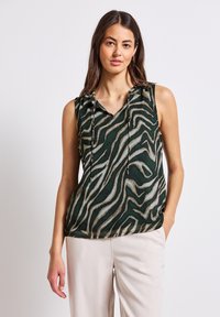 Top senza maniche in tessuto verde con stampa zebras in crema e marrone chiaro. Scollatura a V con lacci al colletto.