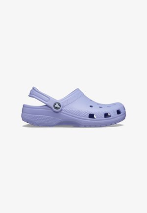 Lavender Crocs clogs made of lightweight foam, featuring ventilation holes, a textured strap, and a branded logo on the side.