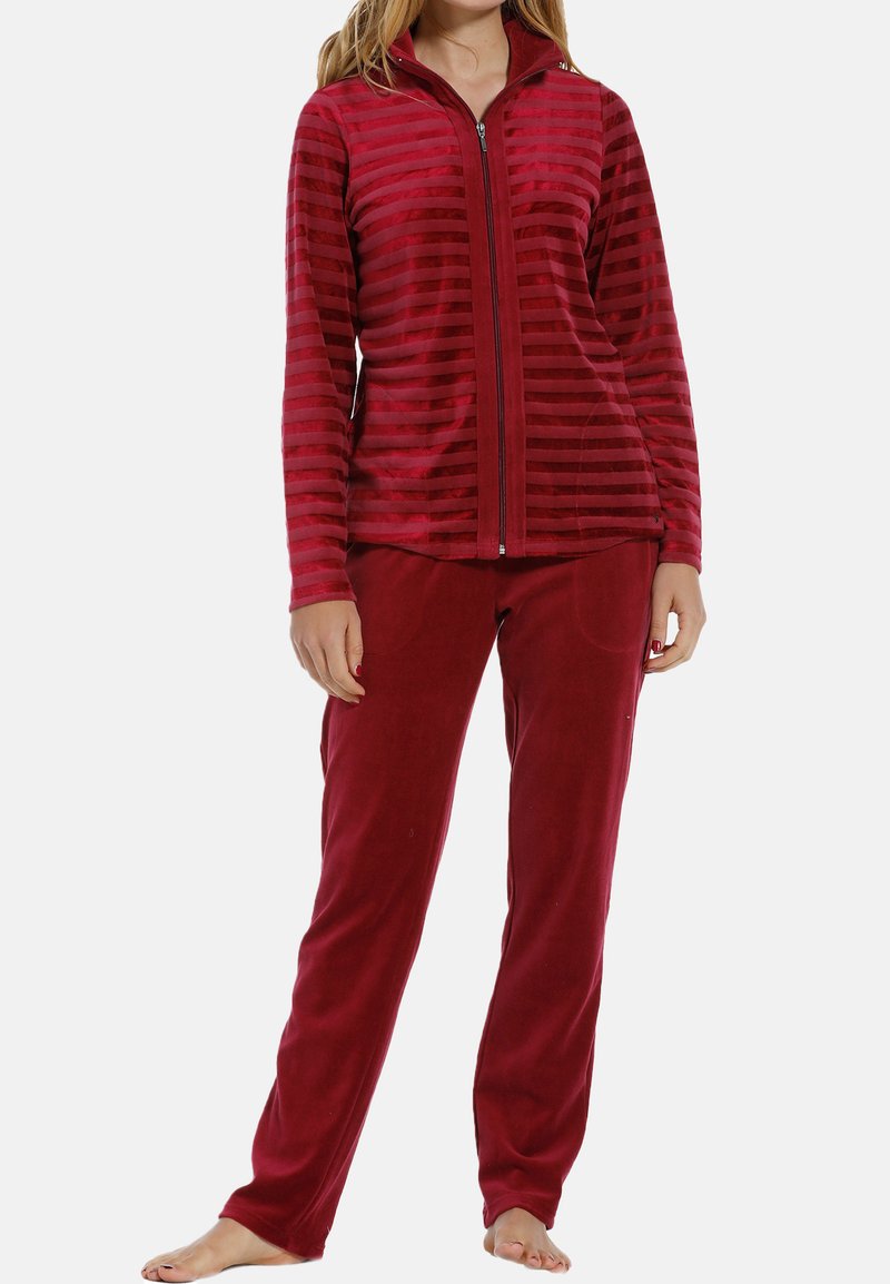 Red fleece pajama set featuring a zip-up jacket with vertical stripes and matching solid-colored pants. Soft, textured fabric.