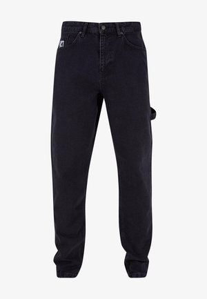 Mustad denim püksid, millel on mugav lõige, ees on taskud, küljes tööriistade hoidmiseks mõeldud silmus ja diskreedid õmblusdetailid.