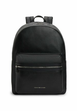 Black textured leather backpack with front zippered pocket, dual zipper main compartment, padded shoulder straps, and small gold Tommy Hilfiger logo.