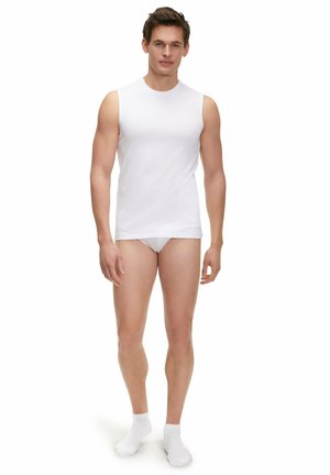 White sleeveless undershirt made of smooth fabric, paired with white briefs and ankle-length white socks. Model stands upright.