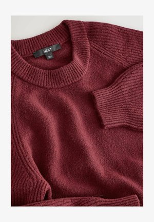 Maroon textured sweater with a ribbed neck and cuffs, featuring a soft fabric and relaxed shape. Label reads "NEXT."