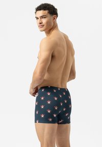 Boxers bleu marine avec un motif répétitif de cornets de glace et de ballons, fabriqués en tissu doux et extensible pour le confort.