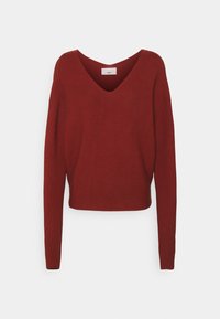 Red knitted sweater with a V-neck, long sleeves, and a cropped design. Textured fabric with ribbed detailing. Simple, solid color.