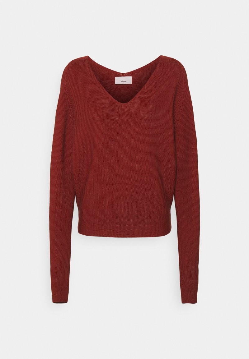 Red knitted sweater with a V-neck, long sleeves, and a cropped design. Textured fabric with ribbed detailing. Simple, solid color.