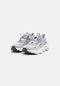 Gray athletic shoes with mesh upper, textured detailing, woven laces, padded collar, and contrasting white outsole with black accents.
