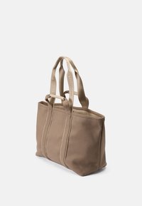 Brown fabric tote bag with two beige handles, featuring structured sides and stitching details. Simple, functional design.