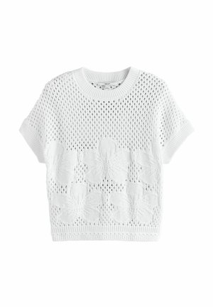 Crop top en tricot blanc avec un motif floral texturé sur la moitié inférieure, manches courtes et col rond côtelé.