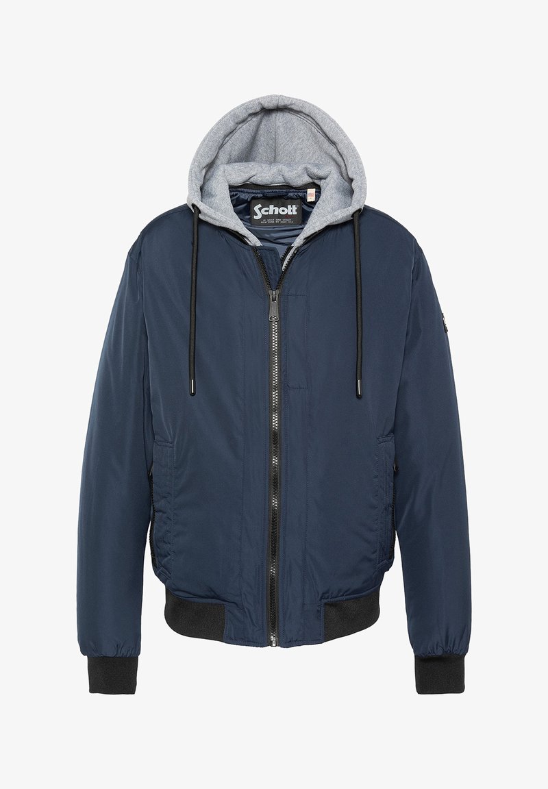 Giacca bomber blu navy con cappuccio foderato in pile grigio chiaro, polsini elastici, zip frontale e due tasche laterali. Dettagli neri sull'orlo.