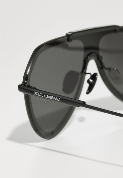 Occhiali da sole aviator neri con lenti scure, montatura in metallo e tempie texture, con il logo bianco "DOLCE & GABBANA" di lato.
