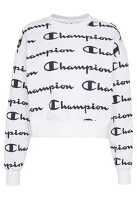 Biała bluza z nadrukiem w czarne napisy i logo "Champion" pokrywające całą powierzchnię, z długimi rękawami, ściągaczami na mankietach oraz okrągłym kołnierzem.